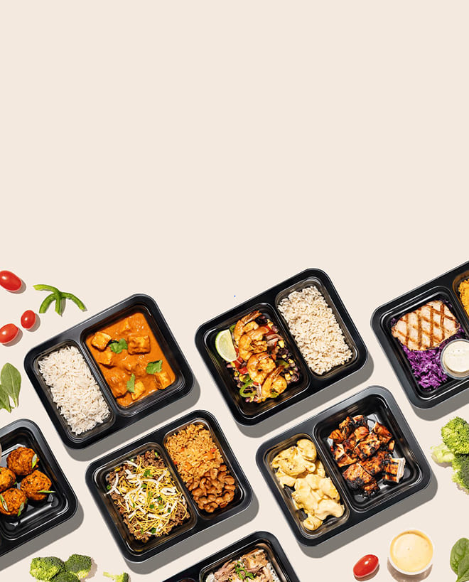 Assorted meal prep containers with different types of food on a light background